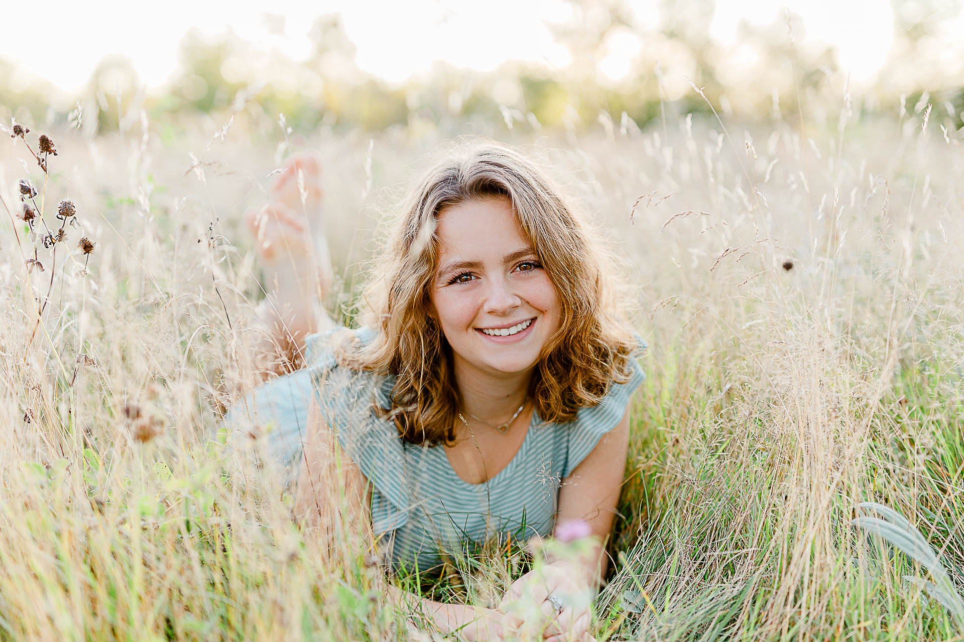 Photo by Maine Senior Portrait Photographer Christina Runnals | Girl laying in a field