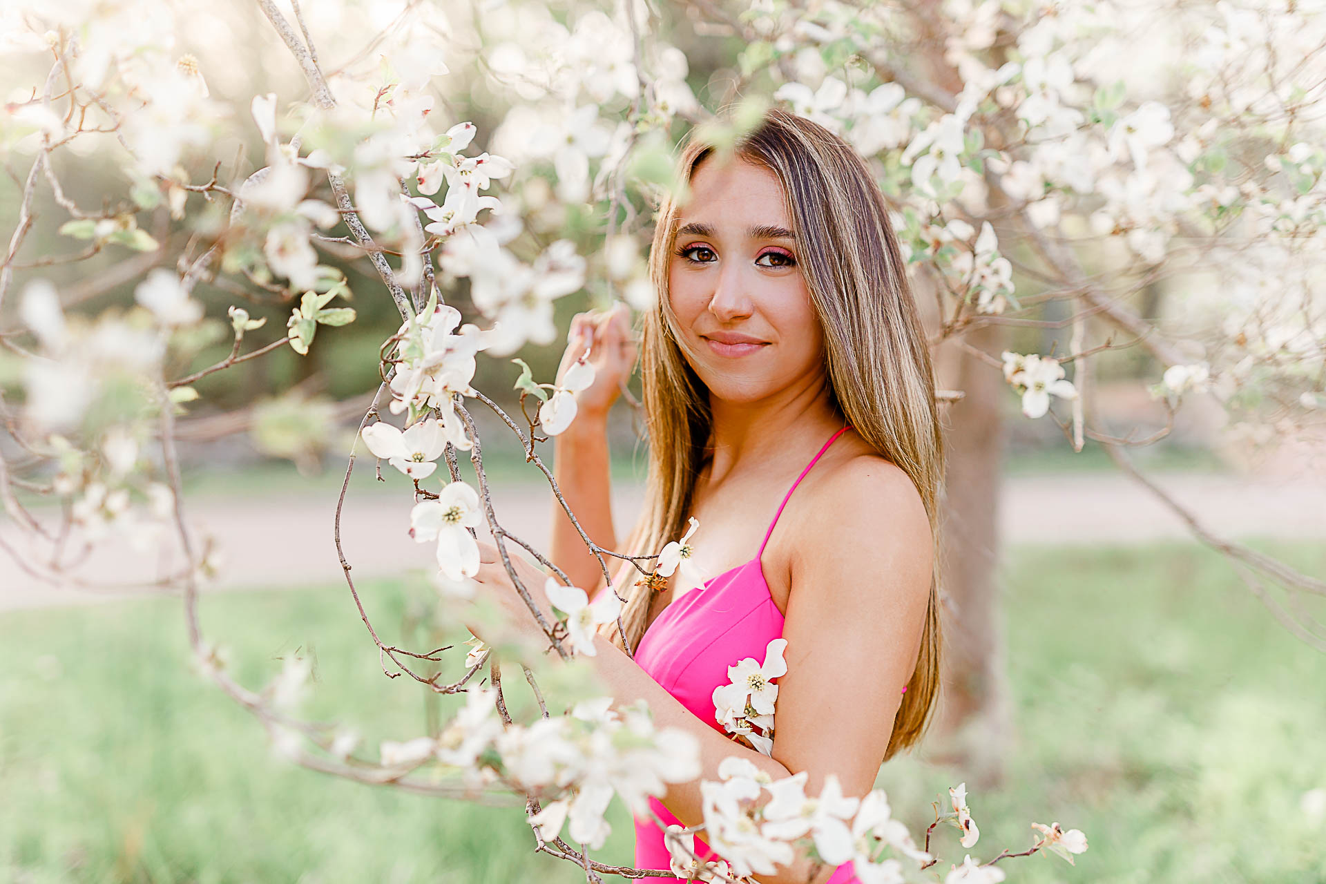 Photos by Hingham Senior Photographer Christina Runnals | A girl wearing a hot pink prom dress with flowers in the background