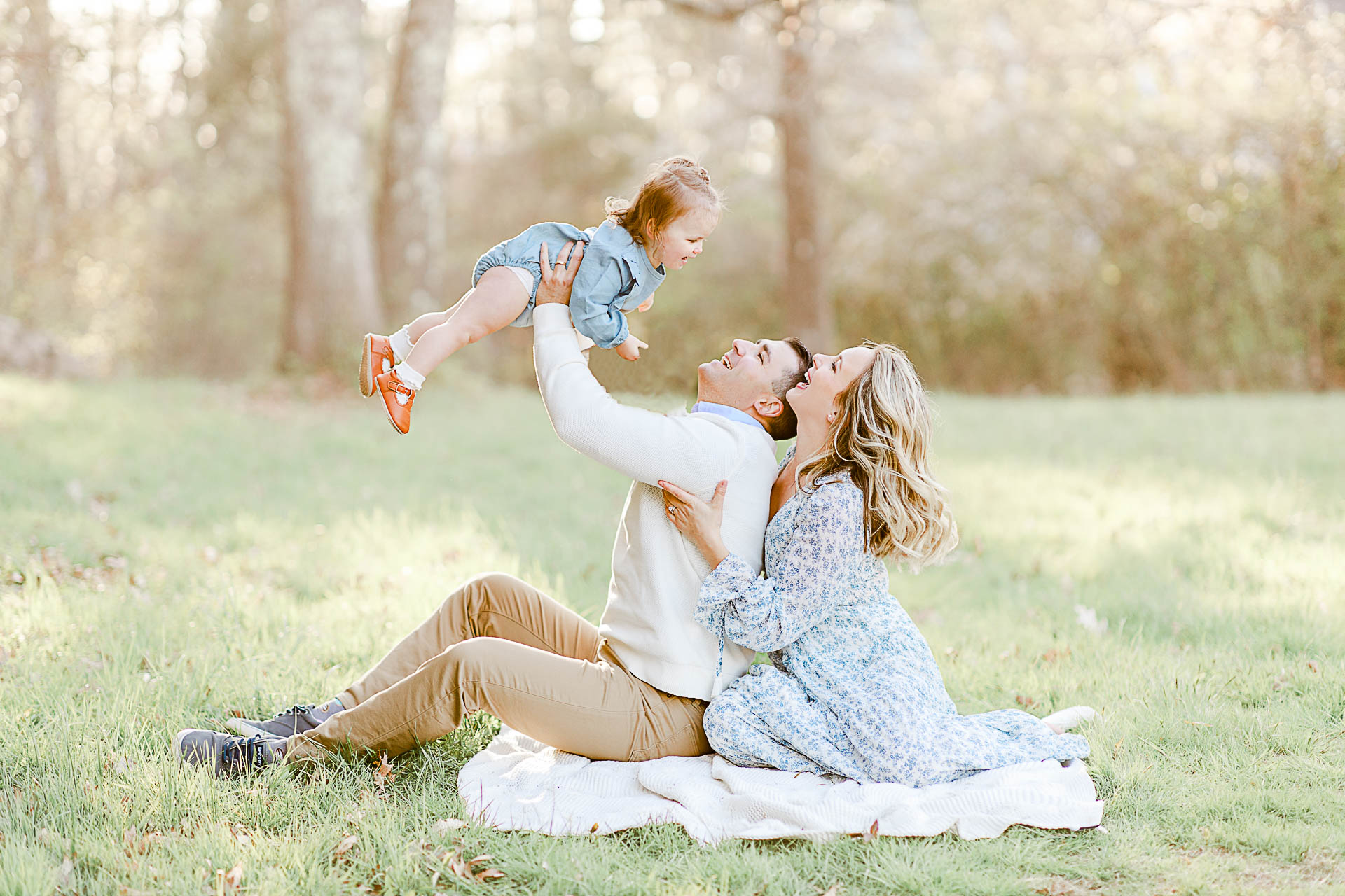 Photo by Boston light and airy Photographer Christina Runnals | Family sitting in field