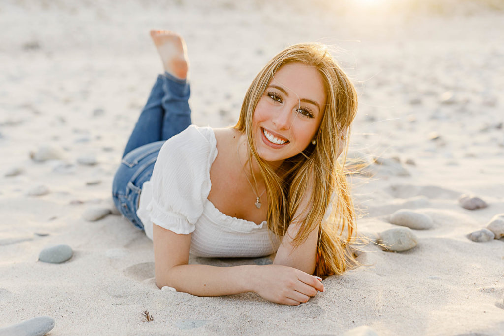 Photo by the best senior photographer in Massachusetts Christina Runnals | girl laying on the beach