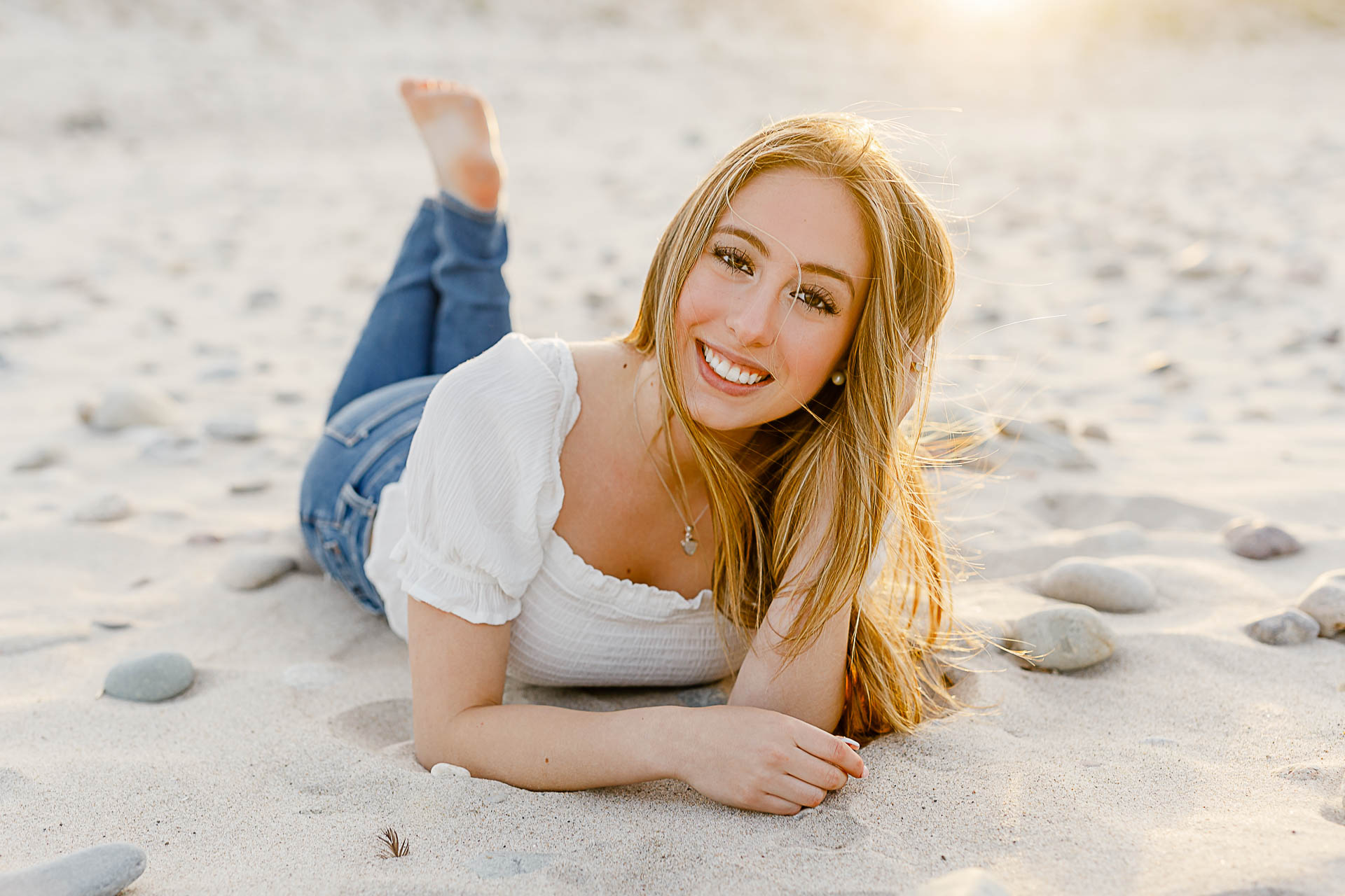 Photo by Arlington senior portrait photographer Christina Runnals | Girl laying on the sand