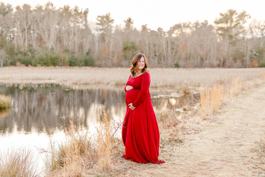Maternity portraits with Massachusetts maternity photographer Christina Runnals | Woman in red maternity photoshoot dress