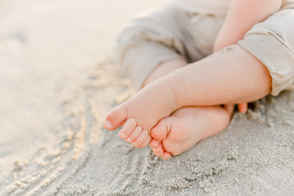 Photo to accompany article on finding the best family photographer in Massachusetts.  Family on the beach with a baby.