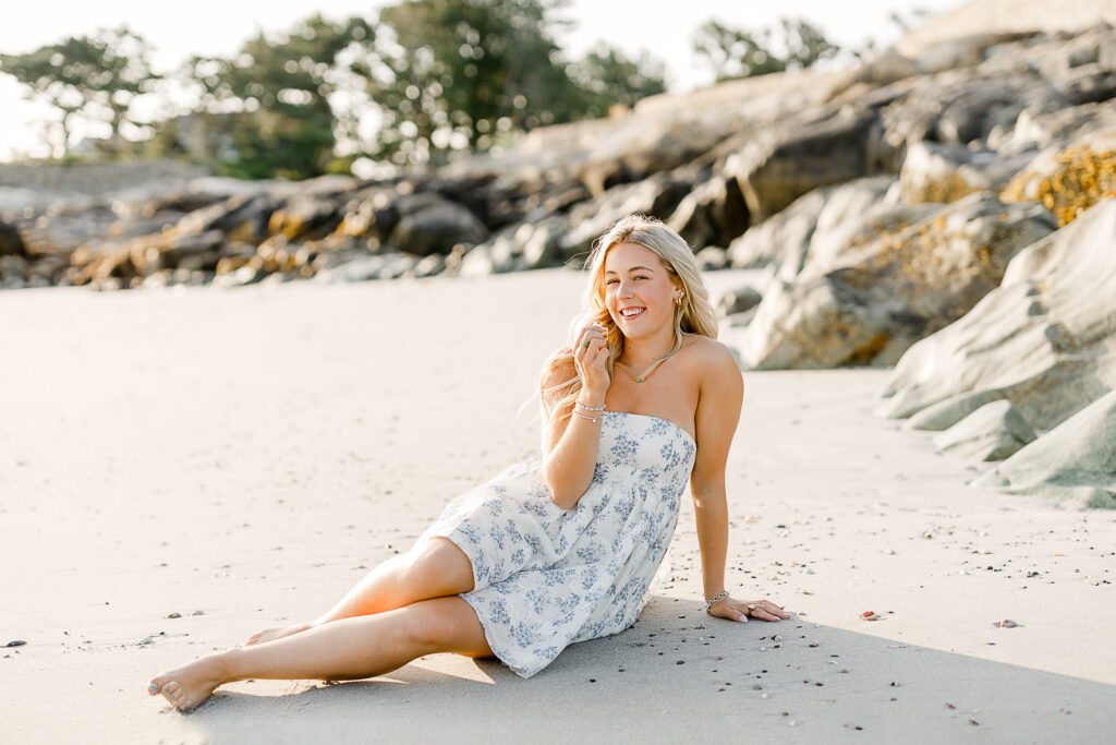 Image by best senior photographer in Massachusetts Christina Runnals | Girl sitting in the sand laughing