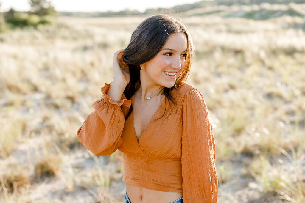 Fall senior pictures in Massachusetts featuring Sydney in a rust orange top.