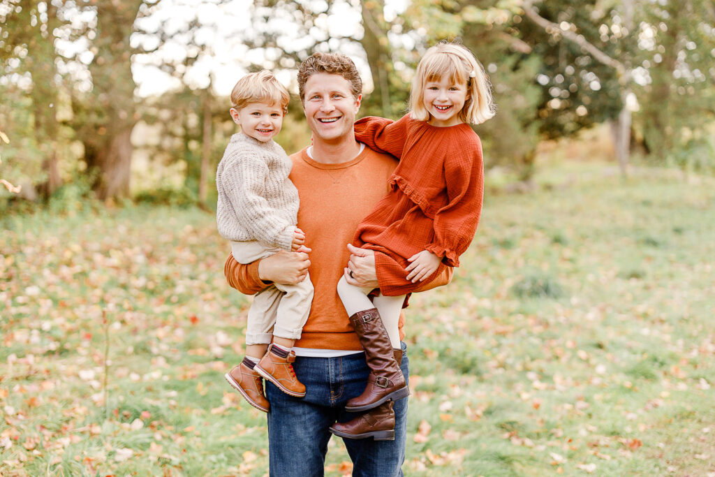 Images of a fall family portrait session by Wayland Massachusetts family photographer Christina Runnals | Dad holding two children