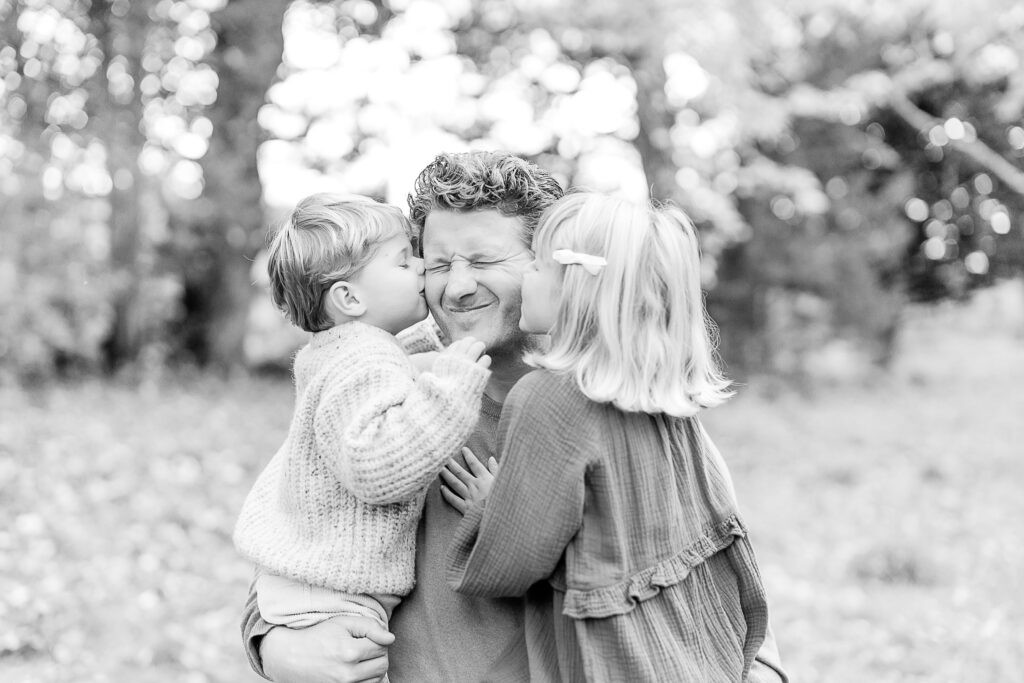 Images of a fall family portrait session by Wayland Massachusetts family photographer Christina Runnals | Dad being kissed by two children