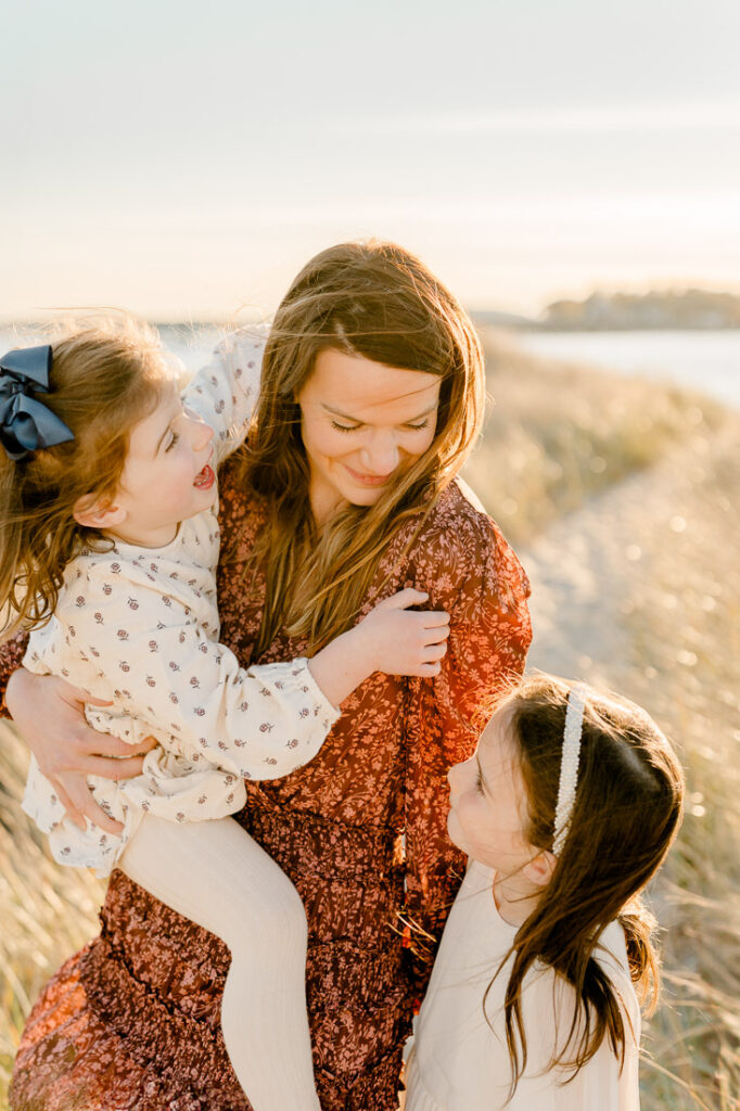 Duxbury MA family photography featuring a family on Duxbury beach in the fall.  Images by Christina Runnals Photography.
