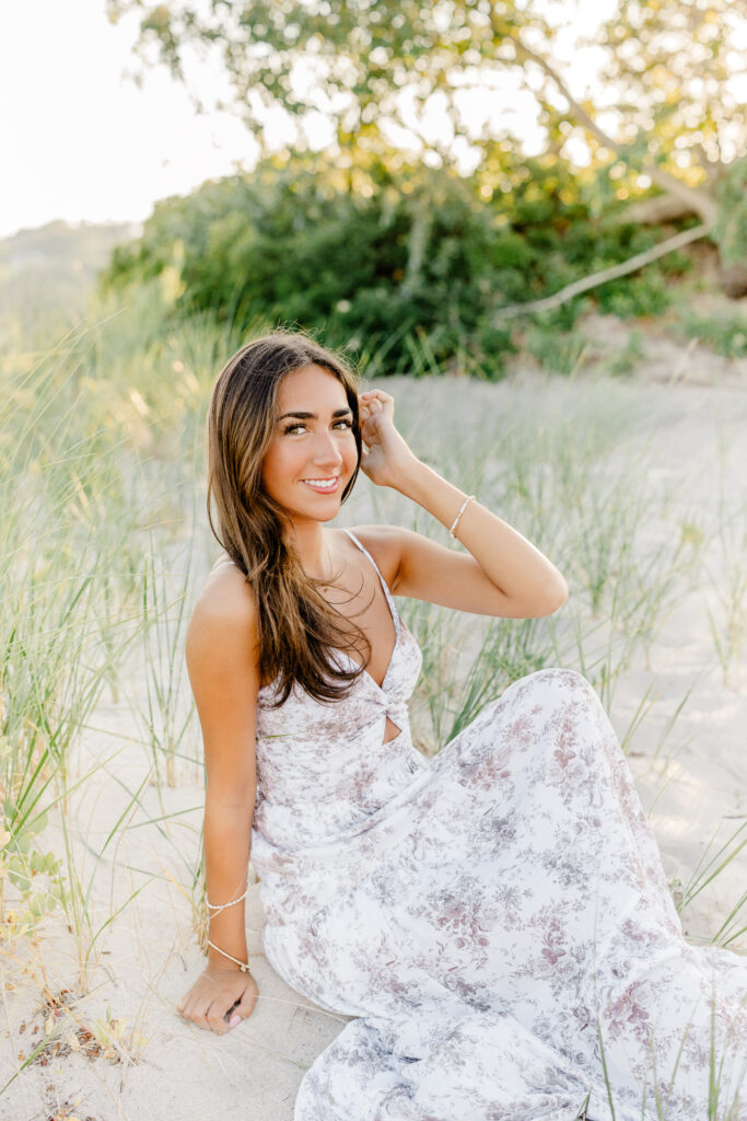 Beach senior portraits South Shore MA with a senior from New Hampshire wearing a long flowing floral dress