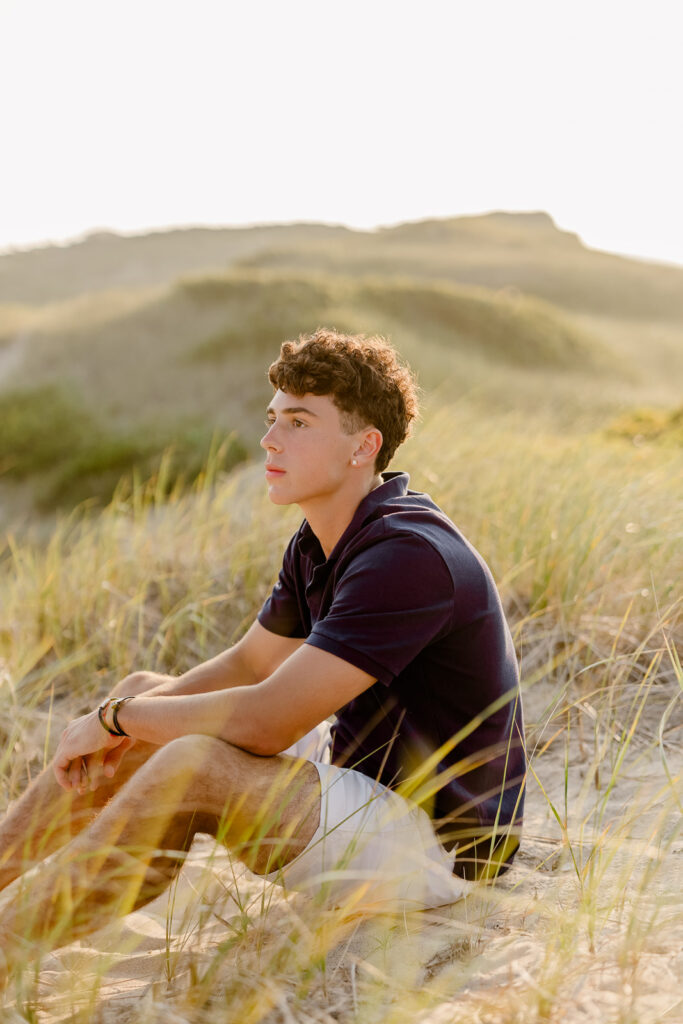 Jack's Nantucket senior pictures taken at sunset in a blue polo and shorts in the dunes