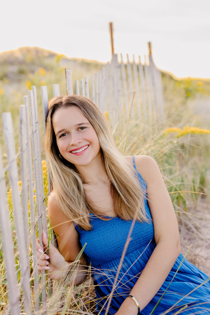 Senior portrait of a girl in a long blue dress by Stow MA senior photographer Christina Runnals
