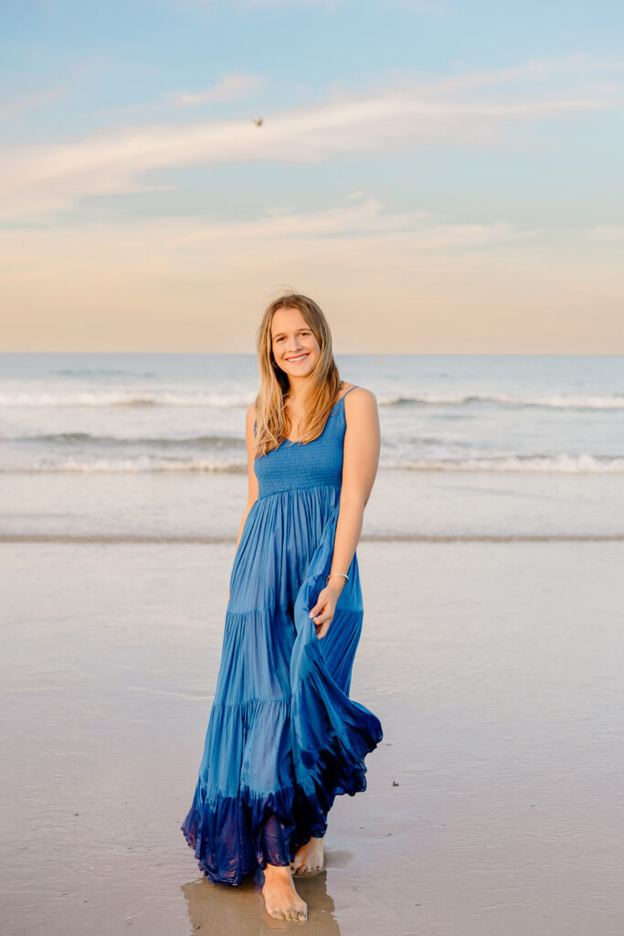 Senior portrait of a girl in a long blue dress by Stow MA senior photographer Christina Runnals